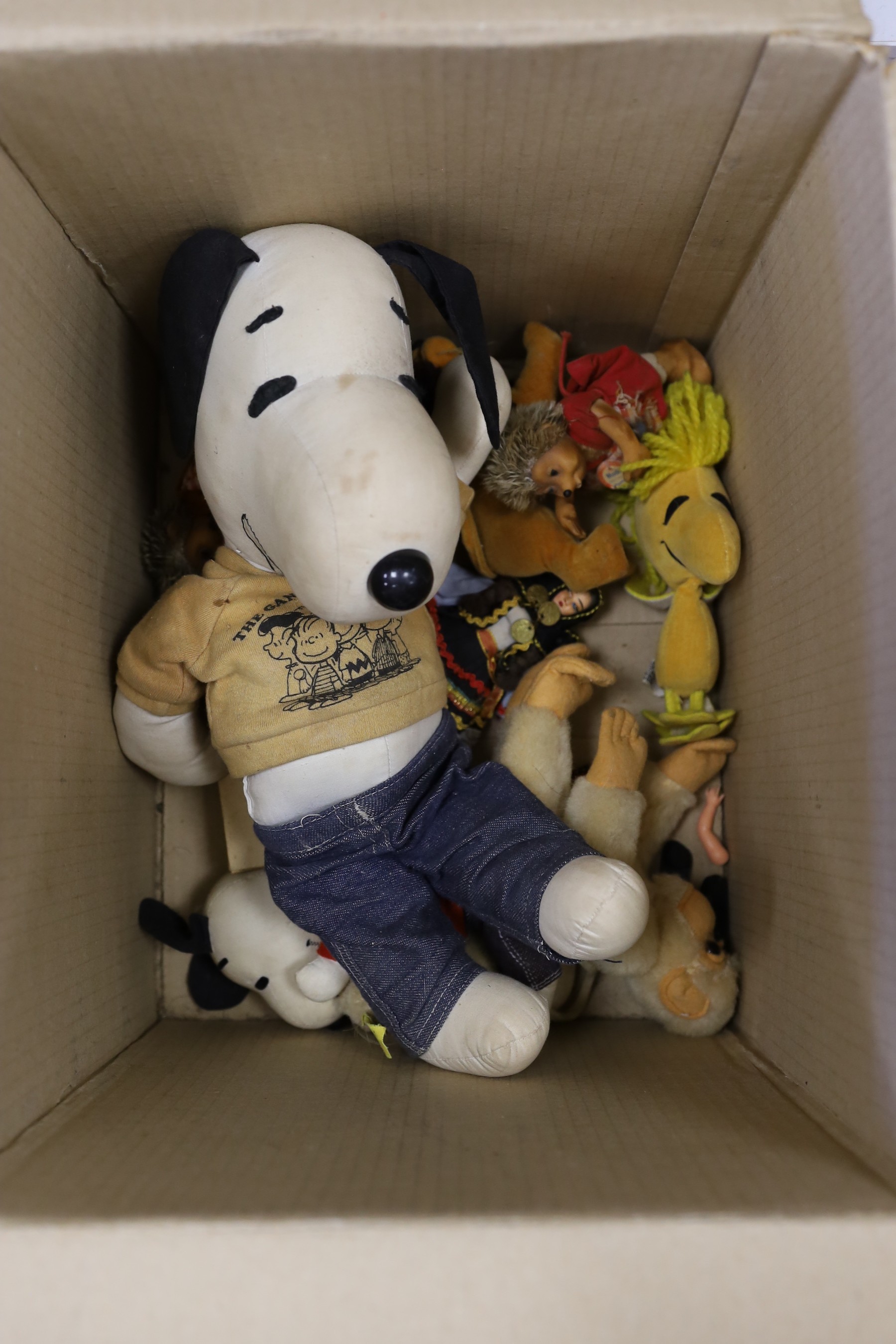 An assortment of soft toys, including Steiff and two dolls